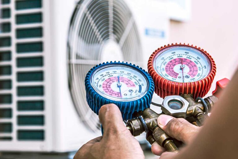A person changing an air filter next to a household air conditioning vent
